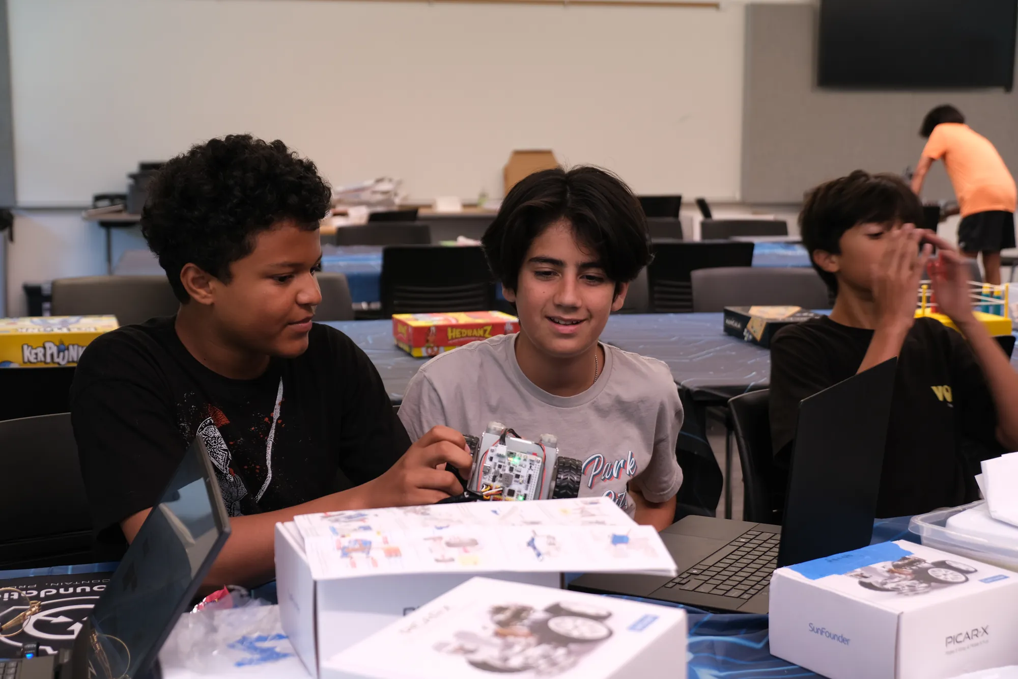 Two students working with a PiCar kit