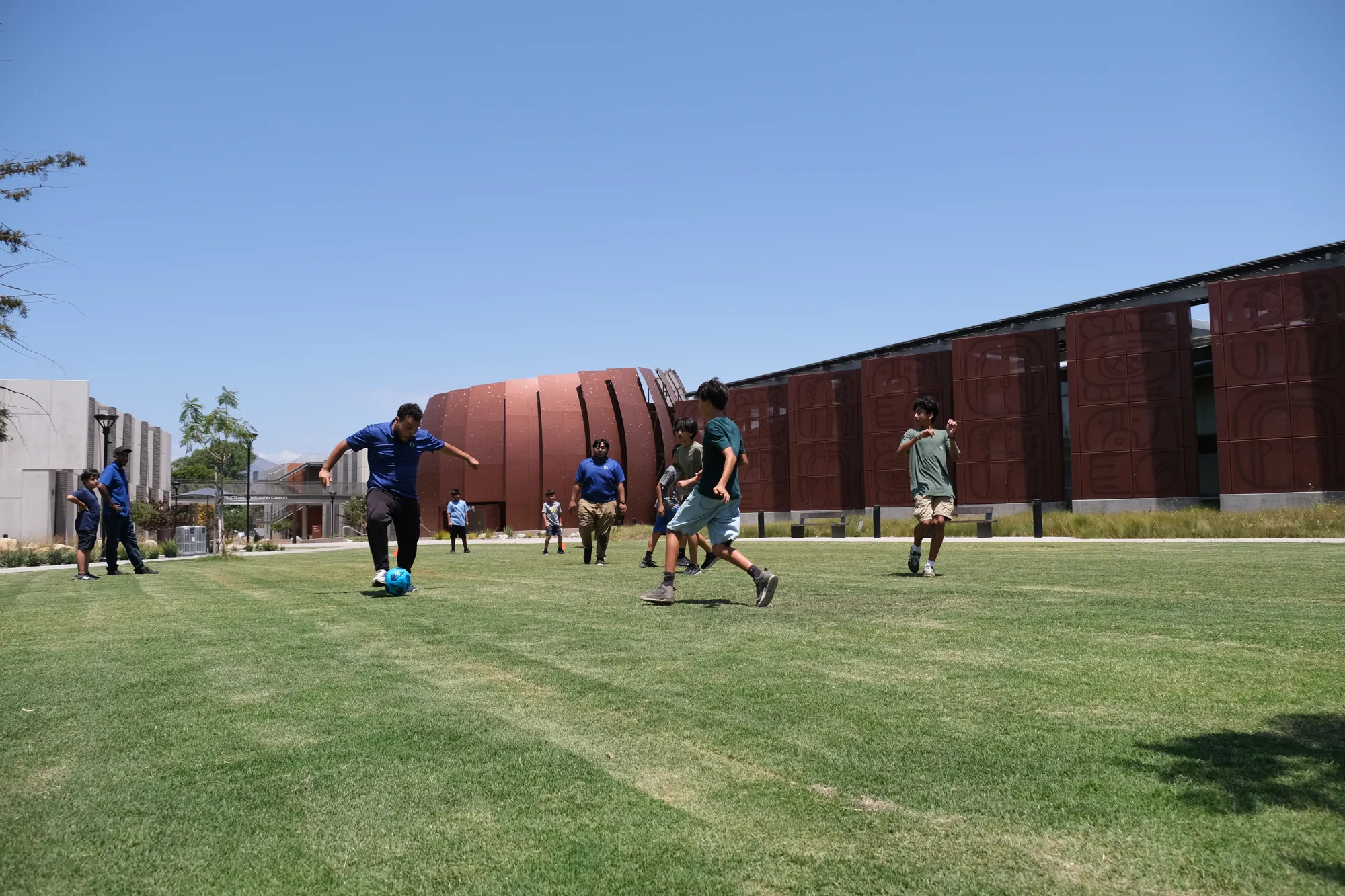 Students playing soccer on the college campus