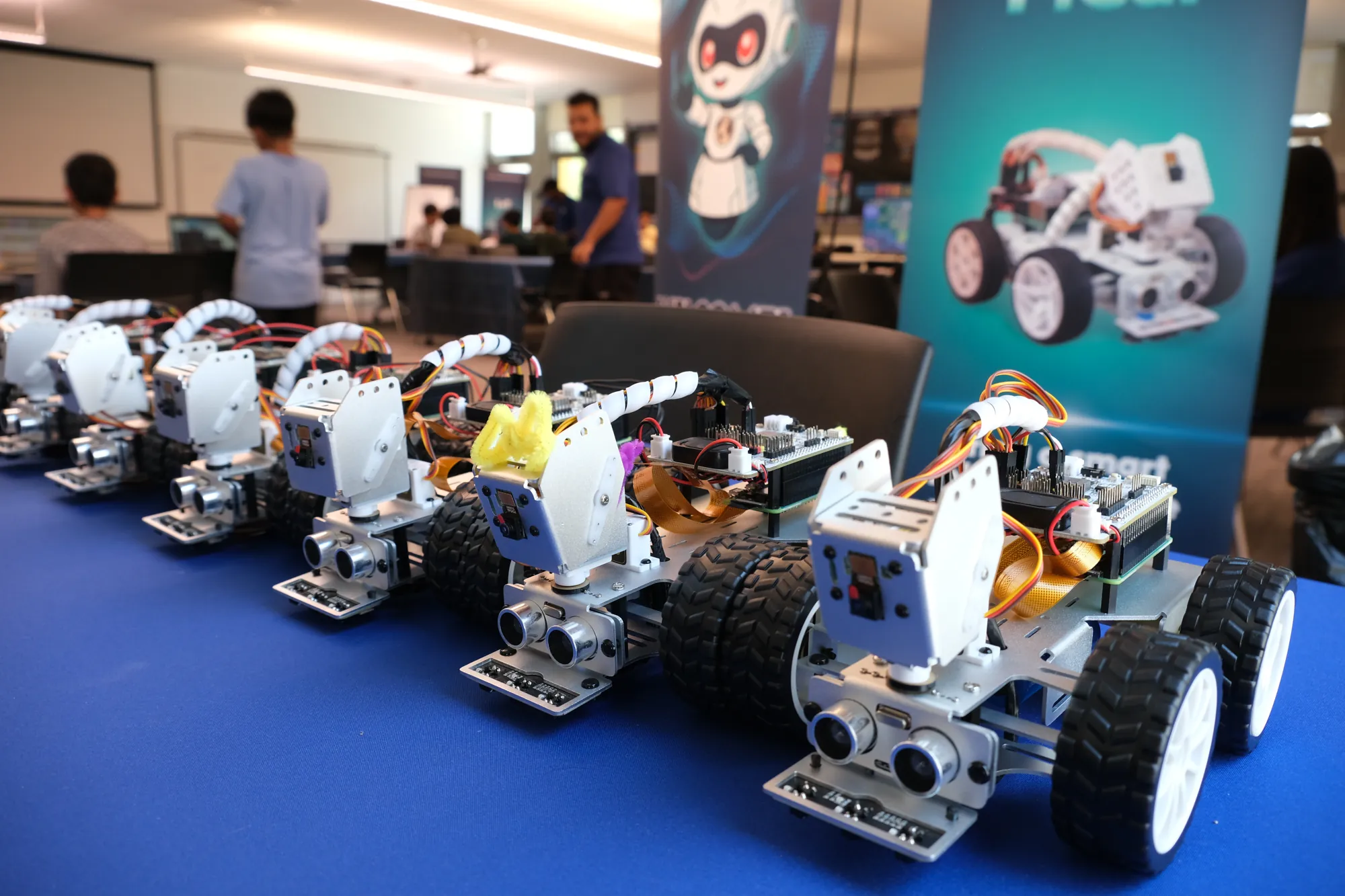 A row of assembled PiCar robots