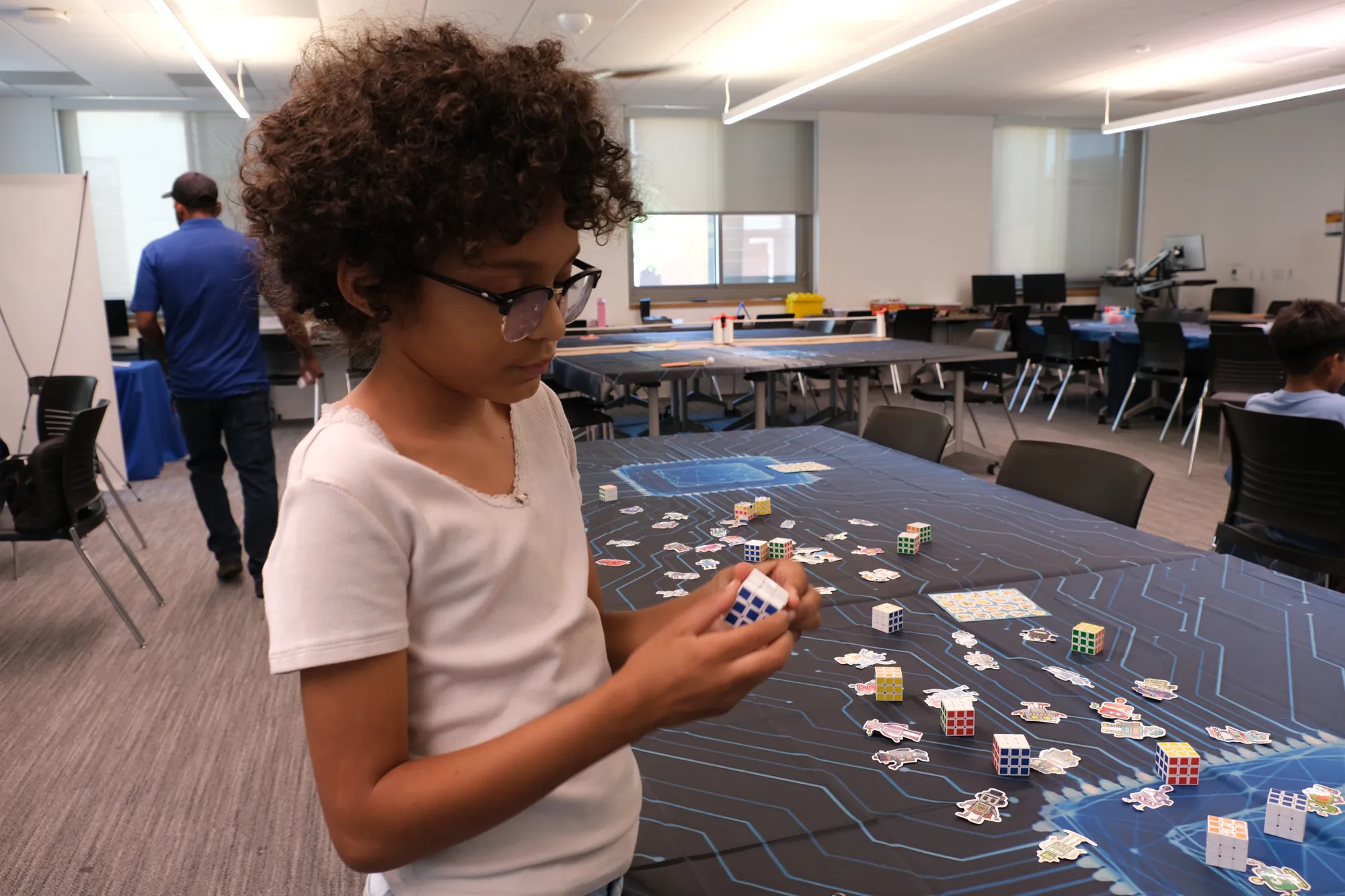 A student solving a Rubik's cube
