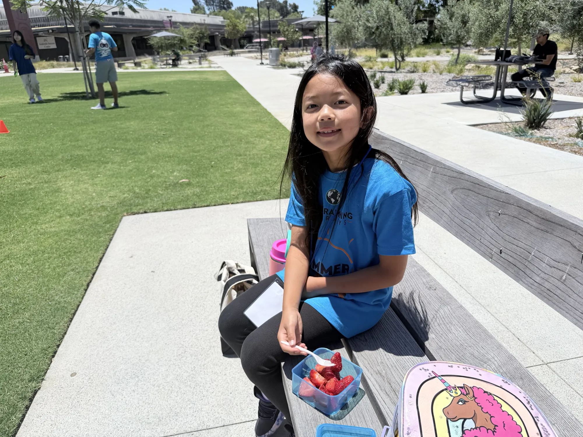 A student on a campus bench during lunch