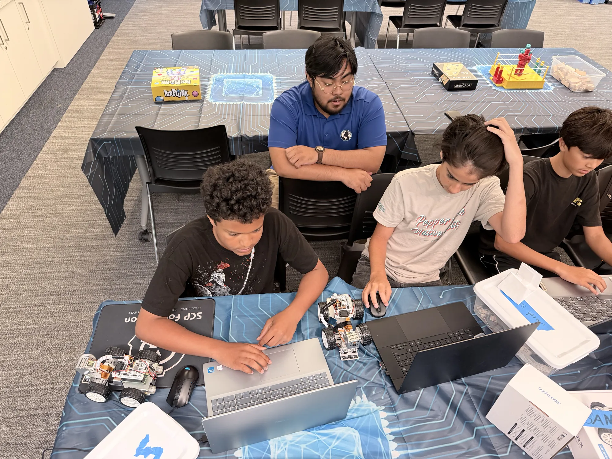 An instructor supervising students coding